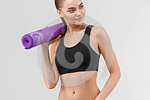 Sport woman in black slim with mat for joga