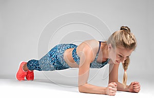 Sport woman doing a plank exercise