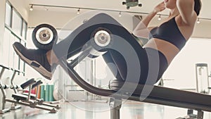 Sport woman doing sit up on sit-up bench in fitness gym. People lifestyles and workout sport training club activity crunching