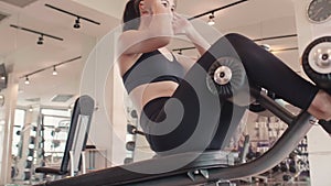 Sport woman doing sit up on sit-up bench in fitness gym. People lifestyles and workout sport training club activity crunching