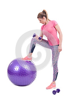 Sport woman exercise with a pilates ball and dumbbells