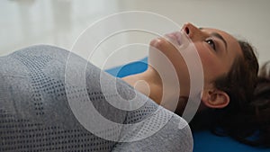 Sport woman female sportswoman doing yoga glute bridge exercise lying on floor on fitness mat Caucasian fit girl lifting