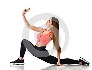 Sport woman gymnastics doing stretching fitness exercise workout and make selfie on her cellphone mobile