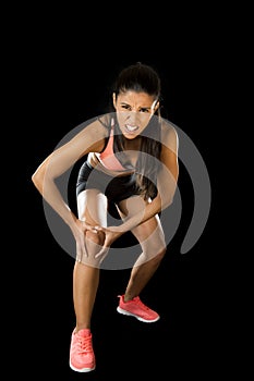 Sport woman holding injured knee suffering pain in ligaments injury or pulled muscle