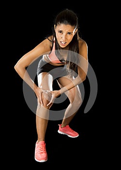 Sport woman holding injured knee suffering pain in ligaments injury or pulled muscle