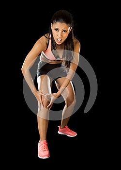 Sport woman holding injured knee suffering pain in ligaments injury or pulled muscle