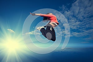 Sport woman jumping and fly over sky and sun