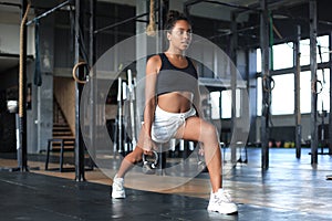 Sport woman with kettlebell in the gym