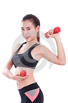 Sport woman with lifting weights and holding apple.