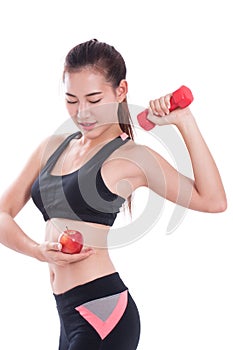 Sport woman with lifting weights and holding apple.