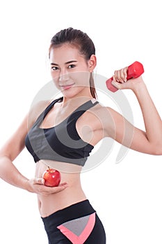 Sport woman with lifting weights and holding apple