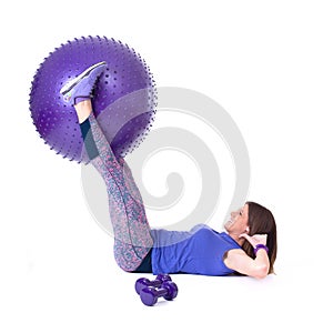 Sport woman with a pilates ball and dumbbells