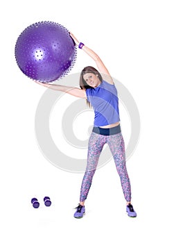 Sport woman with a pilates ball and dumbbells