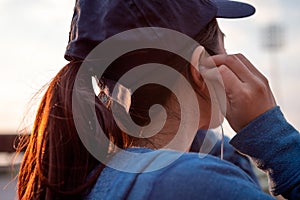 Sport woman putting earphones in ears in the morning