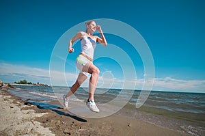 Sport woman running in sea coast