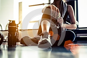 Sport woman sitting and resting after workout or exercise in fit