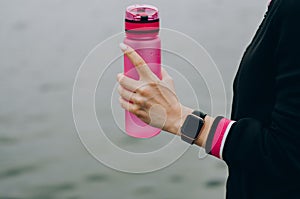 Sport woman sitting and resting after workout or exercise in fitness gym with protein shake or drinking water on floor. Relax