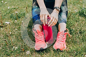 Sport woman sitting and resting after workout or exercise in fitness gym with protein shake or drinking water on floor. Relax