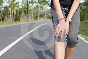 Sport woman suffering with pain on knee injury after exercise.Injury from workout concept