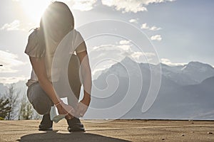 Sport woman in sunny evening mountains