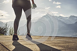 Sport woman in sunny evening mountains