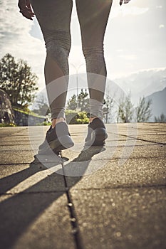 Sport woman in sunny evening mountains