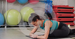 Sport woman training legs stretching in fitness mat in gym club. Flexible fitness woman stretching legs muscles for
