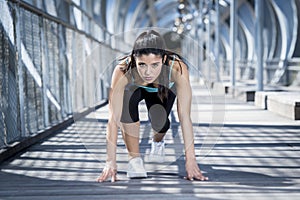 Sport woman training start up grid for running race in urban training workout photo