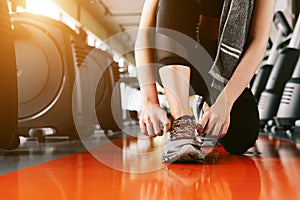 Sport woman tying sneakers rope. Sport center and Fitness gym concept. Healthy and Body build up theme. Sport wear and Fashion
