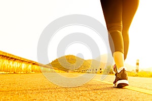 Sport woman walking towards on the road side. Step concept