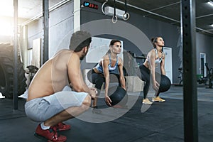 Sport Women Training With Crossfit Balls At Workout Gym