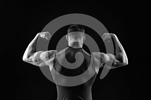 Sport and workout. Man with muscular body and back. Athletic bodybuilder pose isolated on black background. Coach sportsman in ves