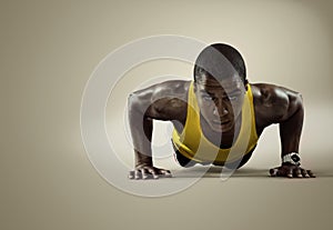 Sport. Young athletic man doing push-ups