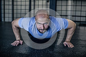 Sport. Young athletic man doing push-ups. Muscular and strong guy exercising. dressed in a sports uniform