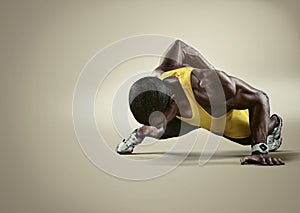 Sport. Young athletic man doing push-ups photo