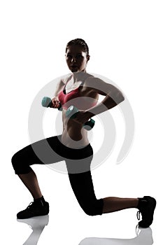 Sport young athletic woman doing squatting with dumbbells, silho