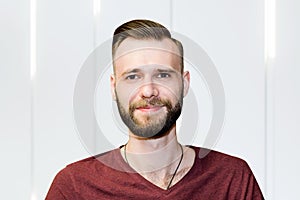 Sport young bearded guy with a modern trendy fade haircut for barbershop