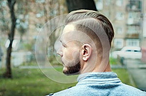 Sport young man with a modern trendy fade profile haircut for barbershop photo