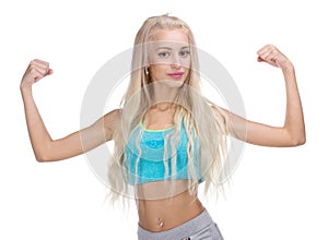 Sport young woman with perfect body showing biceps