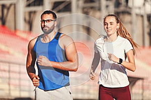 Sportish Couple Jogging At The Football Stadium