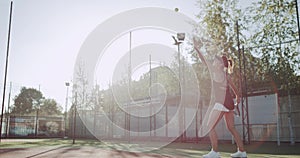 Sportiv woman playing professional tennis on the tennis court , sunny day outside.