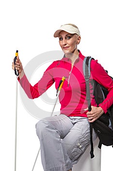 Sportive Active Senior Woman with Nordic Walking Sticks and Backpack. Posing Against Pure White