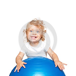 Sportive baby playing with fitness ball.