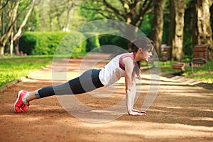 Sportive girl working out doing push ups press exercise