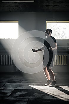 Sportive Man Has Cardio Workout With Skipping Rope .