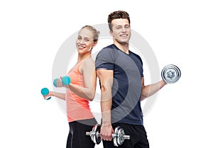 Sportive man and woman with dumbbells