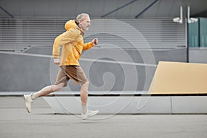 Sportive Mature Man Running In Urban City