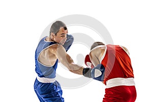 Sportive men, two professional boxer in sports uniform practicing punch isolated on white background. Concept of sport
