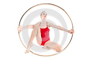 Sportive rhythmic gymnast holding hoop in hands