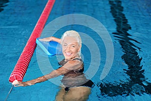 Sportive senior woman in indoor pool